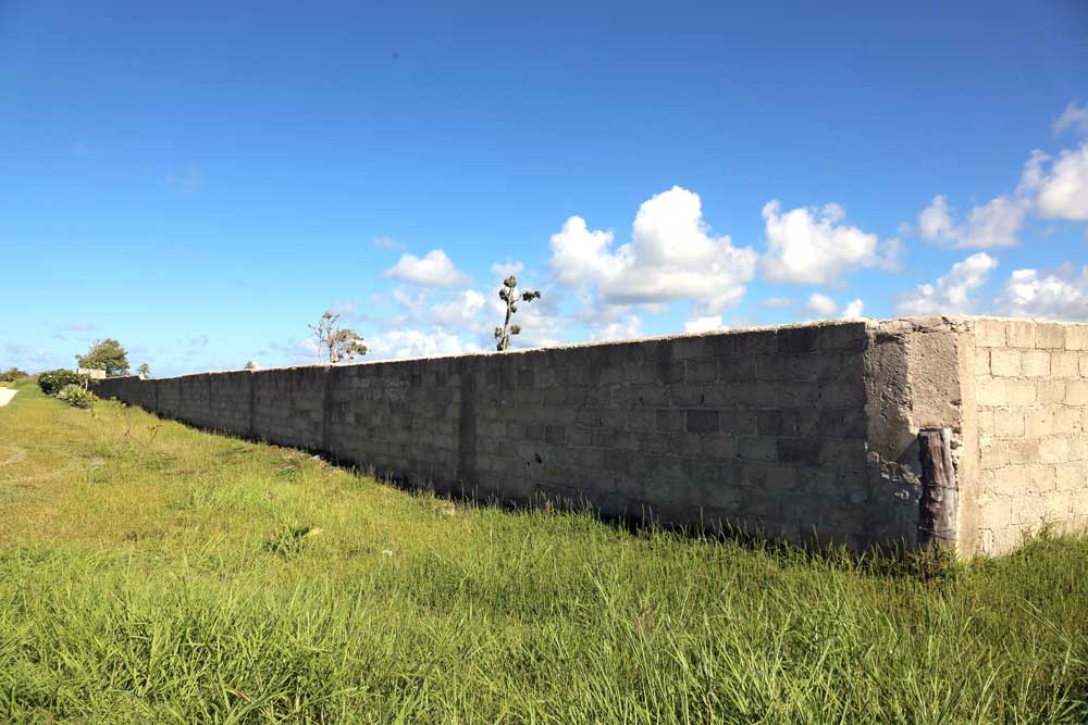 Around 86 hectares of open land, a wall has been erected around the construction site for Rainbow City. It will eventually become a mini city for foreigners. Photo: RFA