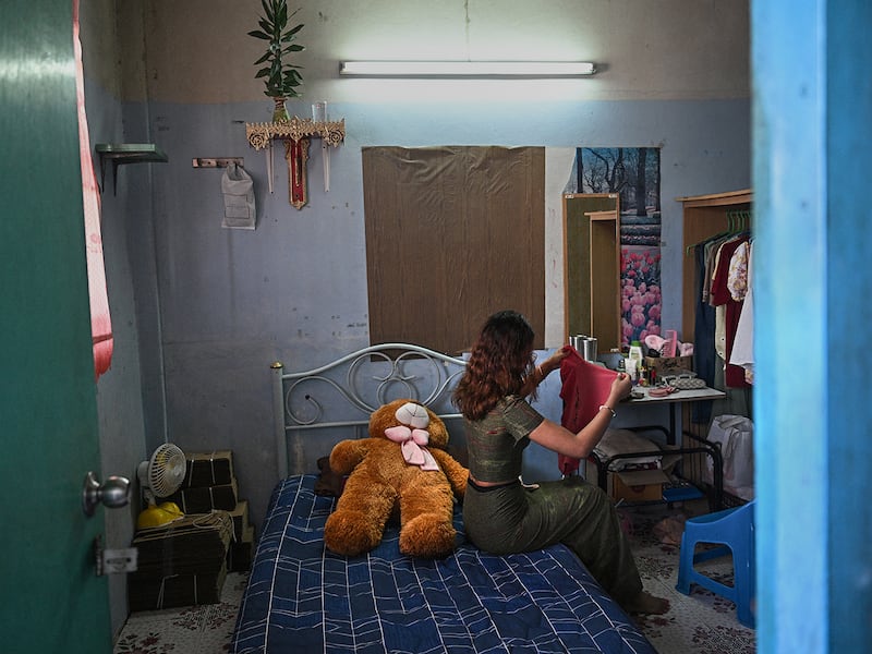 "Khaing," a former teacher with the Civil Disobedience Movement, folds clothes at her current home in Bangkok, Thailand, June 4, 2024, after fleeing Myanmar to avoid conscription by the military junta.