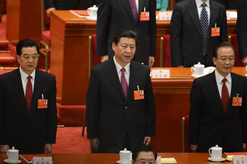 (L-R) Former Chinese president Hu Jintao, newly-elected Chinese President Xi Jinping and former premier Wen Jiabao sing the national anthem at the closing session of the National People's Congress (NPC) at the Great Hall of the People in Beijing on March 17, 2013. Xi said he would fight for a "great renaissance of the Chinese nation", in his first speech as head of state of the world's most populous country.